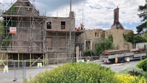 Newell House, a derelict former school surrounded by scaffolding after a fire last month.