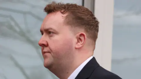 man in suit outside court