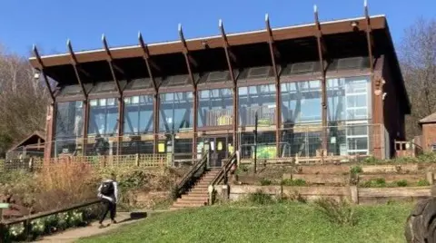 The wooden-structured Epicentre building at Meanwood Farm with grass in front