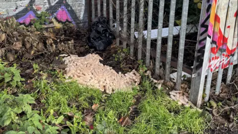 Jake Wesley-Worral A pile of raw sausages showing a smaller pile of sausages in daylight