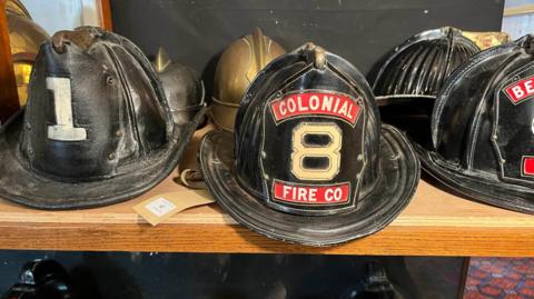 Part of Jack Field's collection of fire fighter helmets