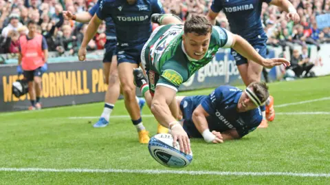Adam Radwan dives over for his first try against Sale Sharks