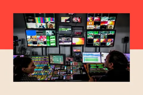 Photo by YURI KADOBNOV/AFP via Getty Images A picture taken on June 8, 2018 shows an unidentified directors of the Russia Today (RT) TV company at in their apparatus room in Moscow