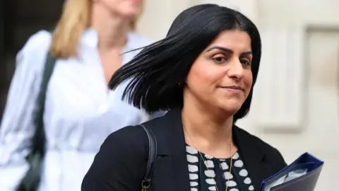 Getty Images Shabana Mahmood walks along Downing St holding a folder