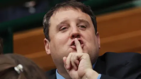 Getty Images Peter Kay pictured jokingly shushing onlookers while at Wimbledon in 2016