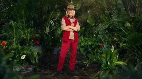 ITV  Jane Moore in her jungle outfit surrounded by plants 