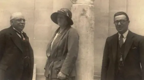 Ghar Dalam Museum and Heritage Malta The black and white image shows three people standing outdoors. Dorothea Bate is standing in the centre.