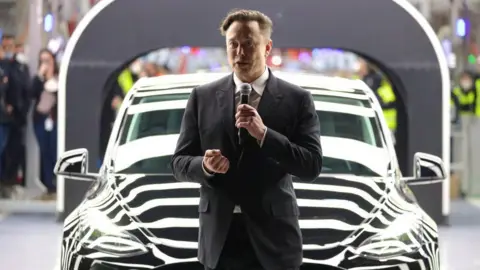 Tesla CEO Elon Musk speaks during the official opening of the new Tesla electric car manufacturing plant on March 22, 2022 near Gruenheide, Germany