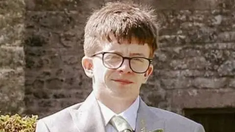 A man in glasses wearing a suit