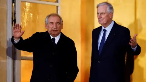 Reuters France's new prime minister François Bayrou (on the left) arrives at the prime minister's residence in Paris where he is greeted by the man who was ousted from the job last week 