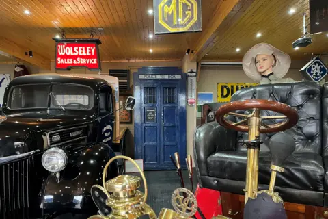 Tardis standing in classic car show room