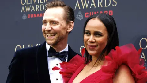 English actor Tom Hiddleston (L) and English actor Zawe Ashton pose on the green carpet for the Olivier Awards 2026 at the Royal Albert Hall in London, Britain, 12 April 2026