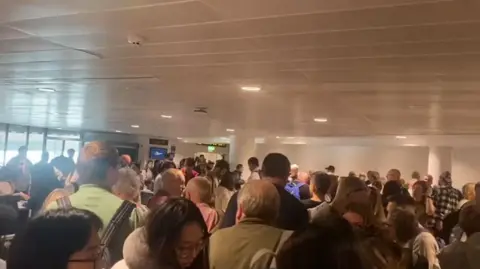 Long queues through security at Manchester Airport