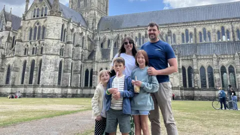 Bradford Law Bradford Law, his wife and three children standing in front of a cathedral