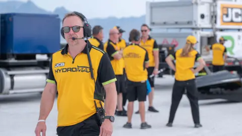 Prodrive Simon Dowson, from Prodrive, at the Bonneville Salt Flats. He is wearing a yellow JCB Hydromax T-shirt.