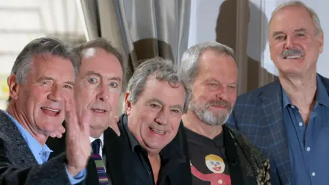 Reuters Group photo of the original cast of the Monty Python. Michael Palin, Eric Idle, Terry Jones, Terry Gilliam and John Cleese, are pictured next to a curtained window. 