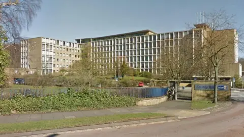 Durham County Council HQ. A slightly brutalist, roughly eight story building. Made up of many windows and concrete. It has the look of a 1960s polytechnic.
