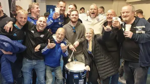 Nathan Parris with his drum and Ipswich supporters