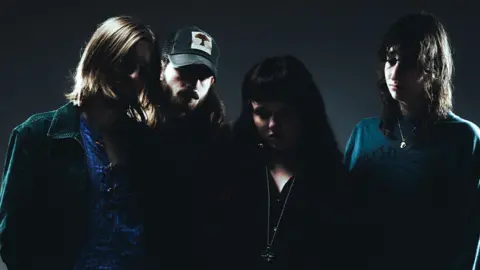 Labyrinthine Oceans The four members of Labyrinthine Oceans are dressed in dark clothing and stood in the shadows. Their faces are hard to make out and obscured in the dark.