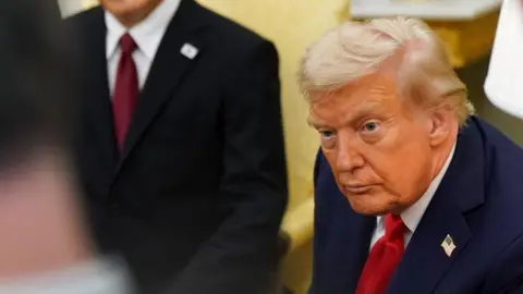 Donald Trump in a suit with US flag badge