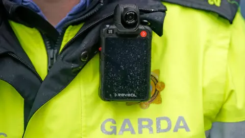 Niall Carson/PA Wire Close-up of Garda officer's uniform and body camera (stock image)