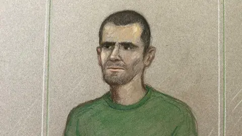 A court sketch of a man in the dock, he is wearing a green top and has short dark hair.