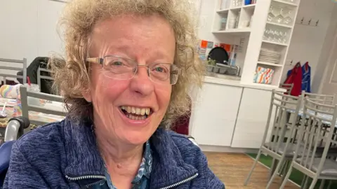 Family handout Alison in a blue jumper and glasses has auburn hair and is smiling at the camera