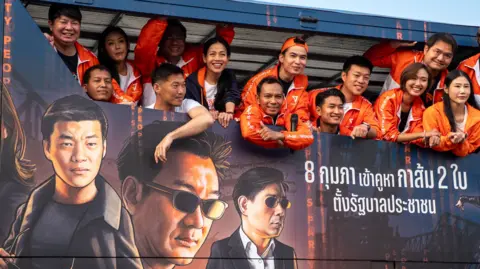 Jonathan Head/ BBC Thanathorn, in white, second from left, and Nattaphong among other People's Party members. 