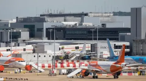Getty Images Several planes on a runway at Gatwick Airport