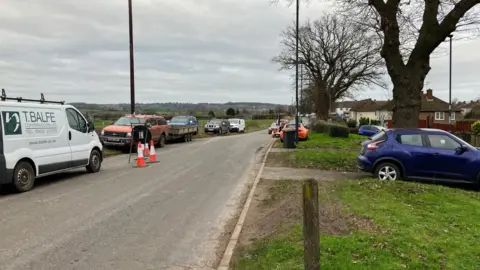 BBC Radbourne Lane with cars parked on both sides