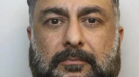 Mohammed Baig looking at the camera in a police mugshot