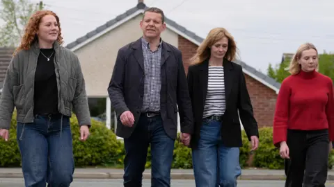 PA Media Rhun ap Iorwerth with an older woman and two younger women