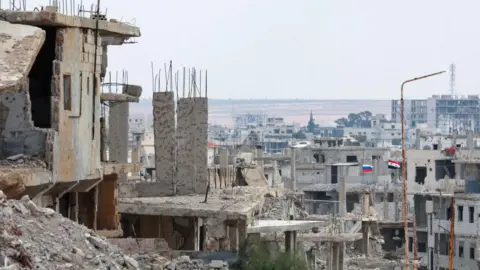 AFP Damaged buildings in the city of Deraa