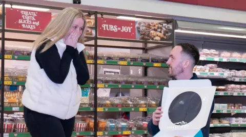 Morrisons Mr Bullock proposing to Hannah McNaughten at the morrisons bakery counter.