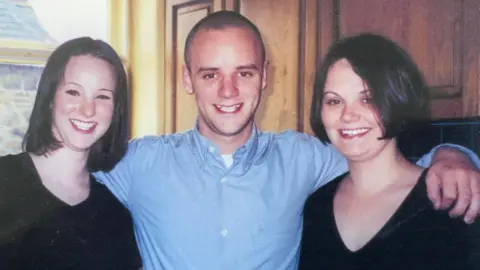 Mu Goode A picture of Mu's three children as young adults with Dan in the centre 