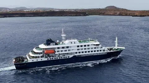 A drone view of the cruise ship MV Hondius, carrying passengers suspected of having cases of hantavirus on board. Big white and black vessel off Cape Verde. 