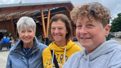 Andrew Turner/BBC Kimberlee King, Nicola Adams and Victoria Warnes standing outside Great Yarmouth Market