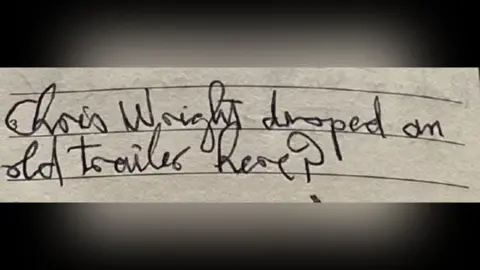 South Yorkshire Police A close-up photograph of a lined notebook page shows a handwritten note in cursive ink that appears to read: “Chris Wright dropped an old trailer here?"