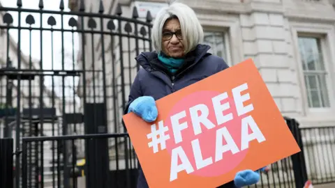 Reuters File photo showing Laila Soueif, mother of jailed Egyptian-British activist Alaa Abd el-Fattah, holding a poster calling for his release outside Downing Street in London (20 January 2025)