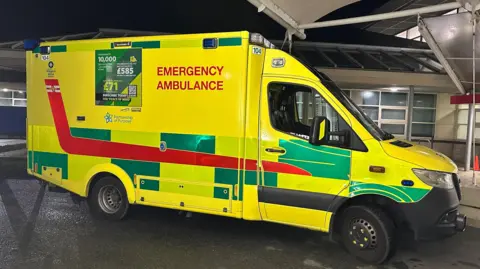 Guernsey ambulance parked at night
