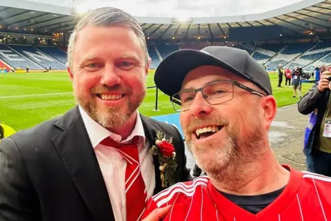 Allan McCarlie Aberdeen fan Allan McCarlie celebrates with team manager Jimmy Thelin
