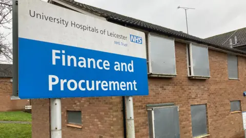 A Leicester Hospital Trust sign says 'Finance and Procurement'. This is from when Hospital Close was run by the local hospital trust and workers at the nearby Leicester General Hospital were tenants here until 2019. 