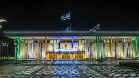 Amir Ohana/X Outside view of the Israeli parliament illuminated in the colours of the Indian flag 