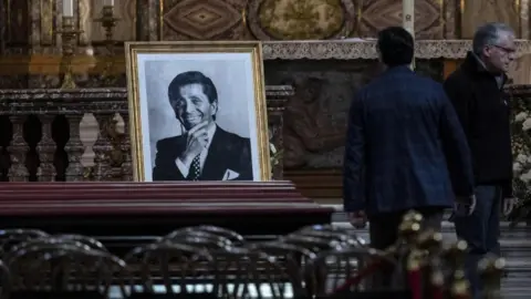 EPA/Shutterstock A framed portrait of Valentino Garavani is displayed on top of his coffin inside the church