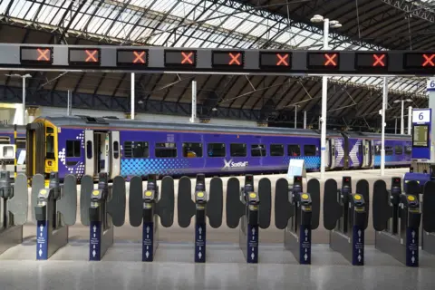 PA Media A stationary train in Queen Street Station