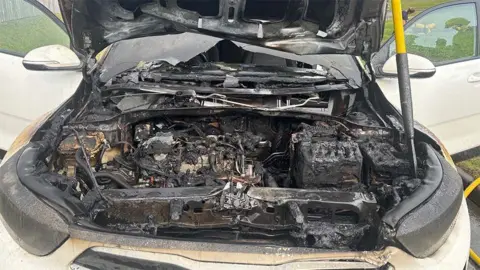 Sian Crooks A close up of the fire-damaged engine. It is completely black and charred