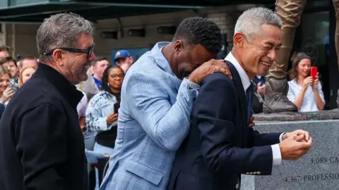 Getty Images Ichiro Suzuki, Edgar Martinez and Ken Griffey Jr. laugh after the bat of the statue is broken during the unveiling of the Ichiro Suzuki statue.