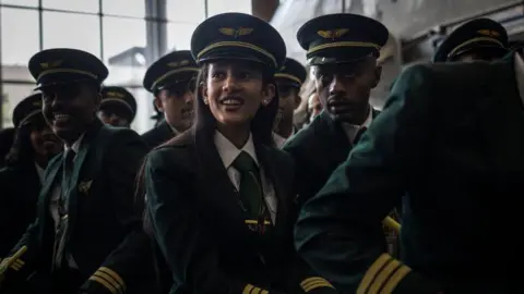 Michele Spatari/AFP Airline pilot students attend their graduation ceremony at the Ethiopian Aviation University in Addis Ababa on June 15, 2024. First inaugurated in 1964, the Ethiopian Aviation University is a strategic asset of the country national carrier that form Ethiopians and foreign pilots, cabin crew and technicians, making it one of the largest aviation training centre in Africa. 