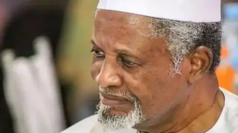 Nigerian billionaire Aminu Dantata wearing a traditional cap