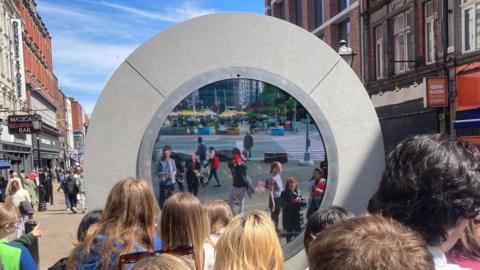 People looking into the portal in Dublin